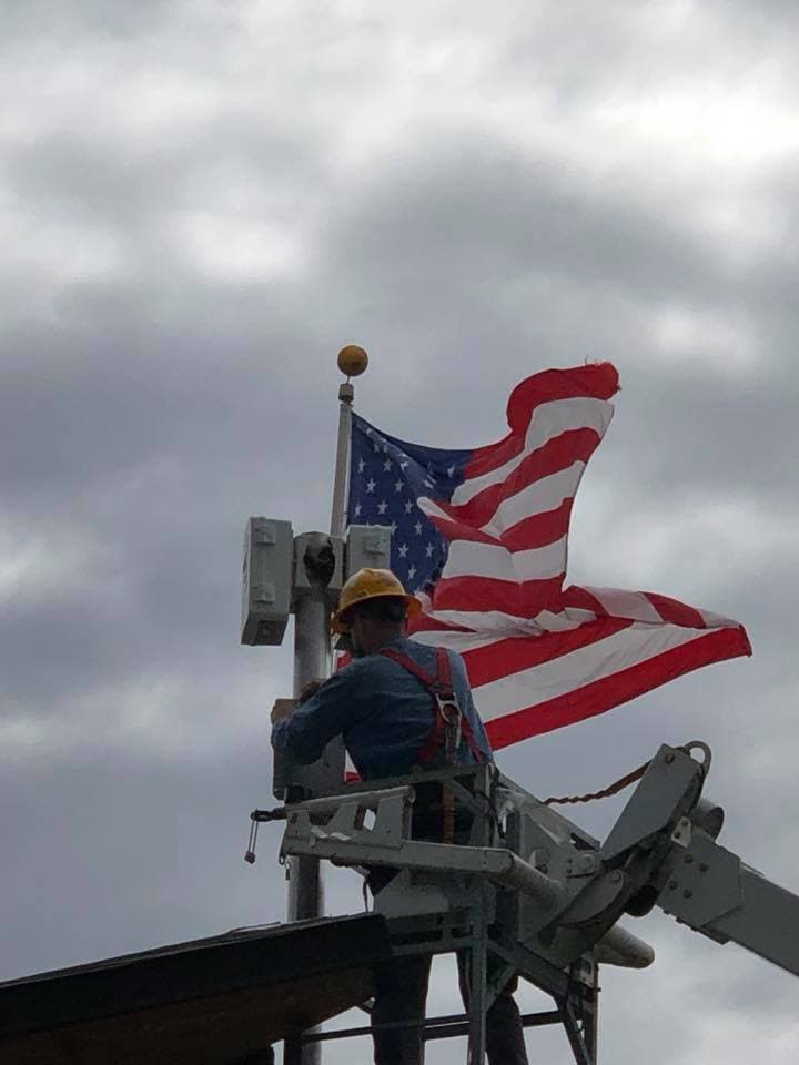 Union electrician working with American flag in background